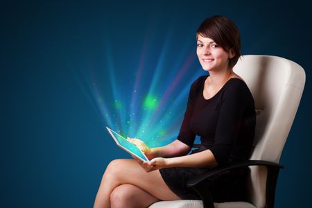 Young business woman looking at modern tablet with abstract lights