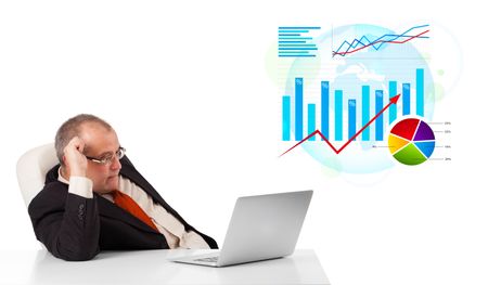 Businessman sitting at desk with laptop and statistics, isolated on white