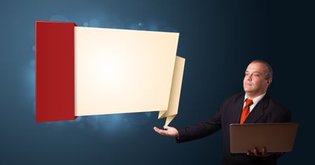 Businessman in suit holding a laptop and presenting modern origami copy space