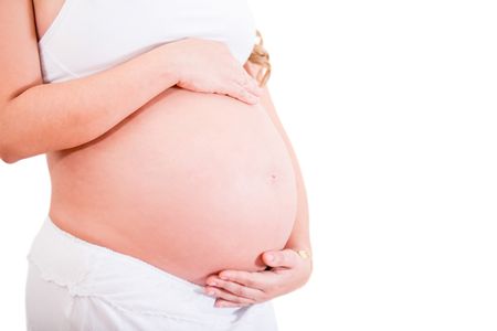 Woman stroking her pregnant belly - isolated over a white background