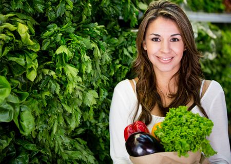 Healthy woman buying fresh vegetables at the supermarket