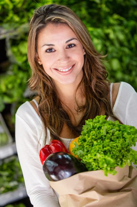 Happy female shopping organic at the grocery store