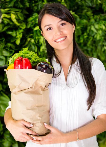 Healthy woman buying fresh food at the local market