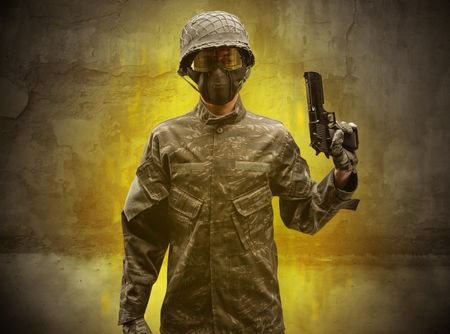 Hazard, menace soldier in a ruined crumbly building with arms on his hand