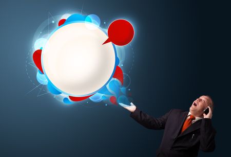 crazy businessman in suite holding a phone and presenting abstract modern speech bubble with copy space