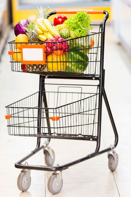 Shopping trolley full of fresh fruits and vegetables