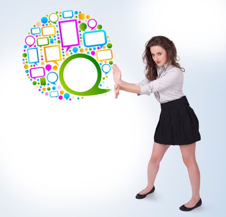 Young business woman presenting colourful speach bubble on bright background