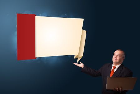 Businessman in suit holding a laptop and presenting modern origami copy space