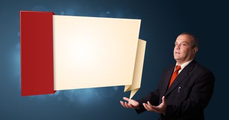 businessman in suit presenting modern origami copy space