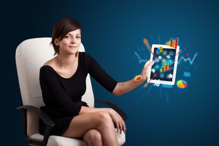 beutiful woman holding modern tablet with colorful diagrams and graphs