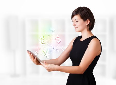 Young business woman looking at modern tablet with currency icons