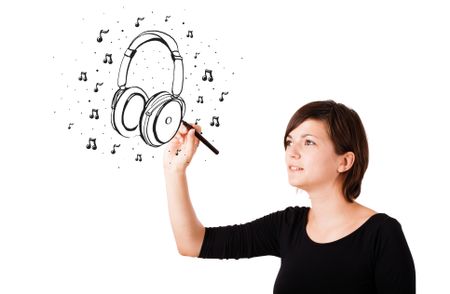 Young girl drawing headphone and musical notes isolated on white