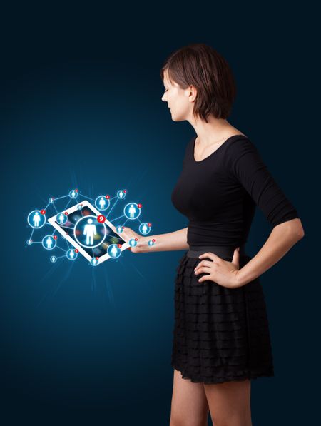 Beautiful young woman holding tablet with social network icons