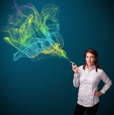 Pretty young lady smoking cigarette with colorful smoke