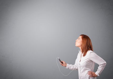 pretty young lady singing and listening to music with copy space