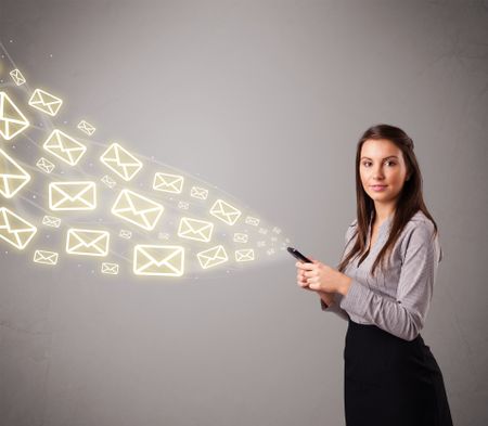 attractive young lady standing and holding a phone with message icons