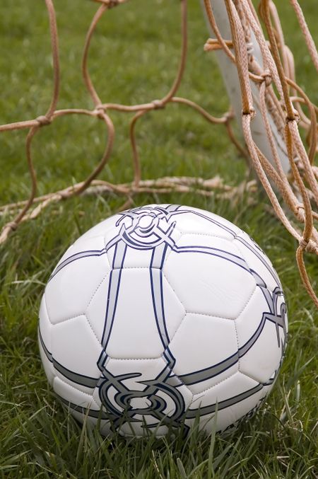 Close-up of soccer ball in corner of goal