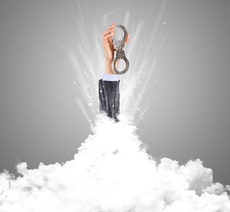 Hand breaking out from cloud