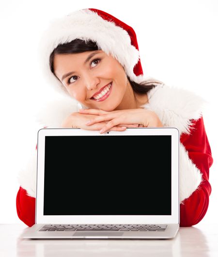 Thoughtful female Santa with laptop - isolated over a white background