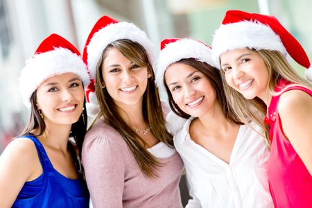 Group of happy Christmas women wearing Santas hat