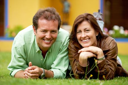 happy-couple-thirties-smiling-lying-grass-12222211 happy couple in their thirties smiling and lying on the grass outdoors