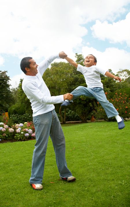 family lifestyle portrait of a dad with his son having fun outdoors