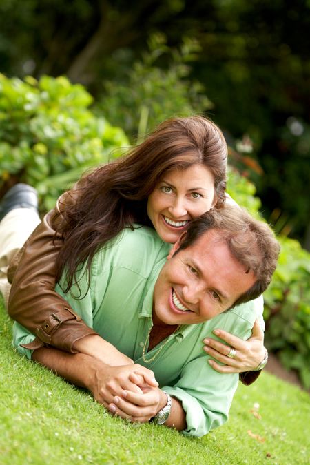 happy couple in their thirties smiling outdoors