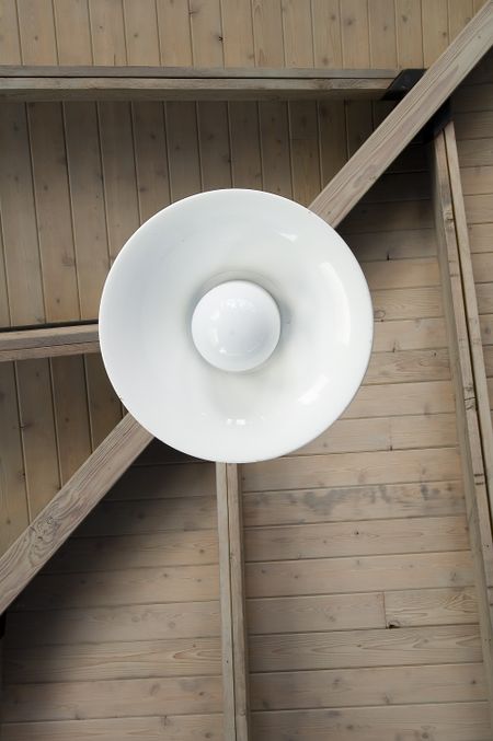 Light fixture hanging from ceiling of picnic shelter