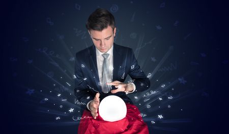 Gorgeous businessman looking to inspiration in a magic ball in his lap and doodle concept