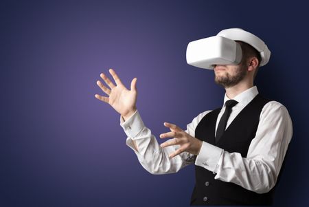 Businessman with white vr glasses in an empty room with no wallpaper