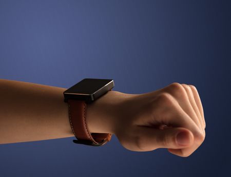 Close up female hand with smartwatch and dark background and black screen