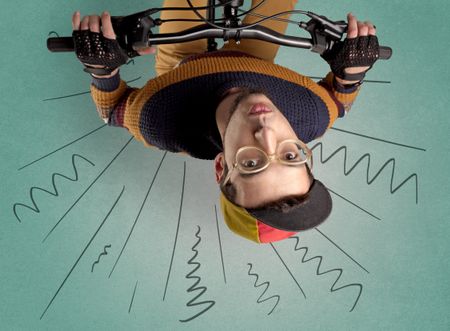 Extreme young cyclist with doodle on the background