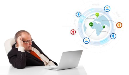 businessman sitting at desk and looking laptop with globe and social icons, isolated on white