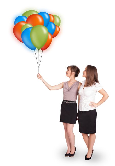 Beautiful young women holding colorful balloons