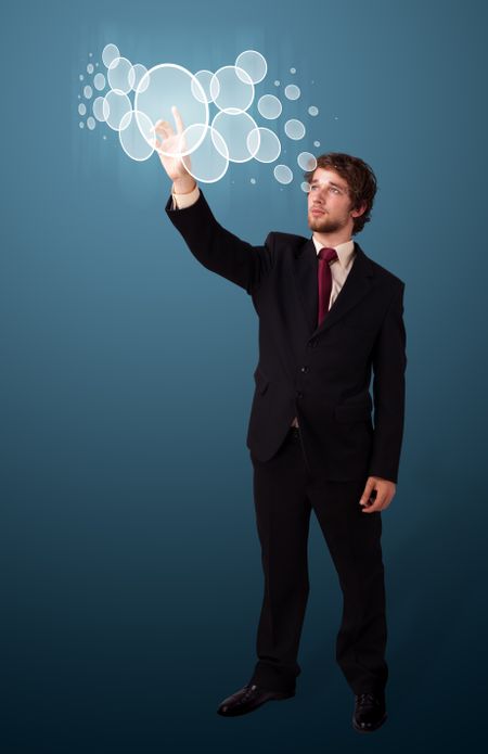 Businessman pressing high tech type of modern buttons on a virtual background