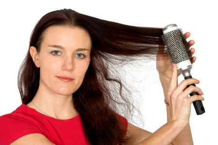 beautiful female model combing her hair over a white background