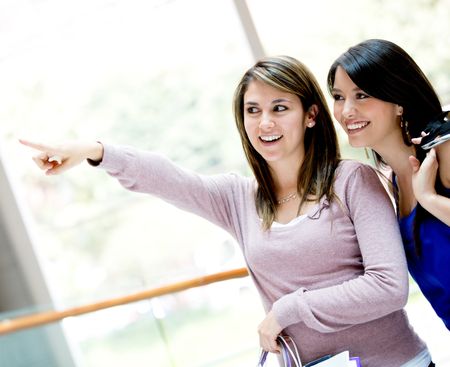 Women pointing away at the shopping center