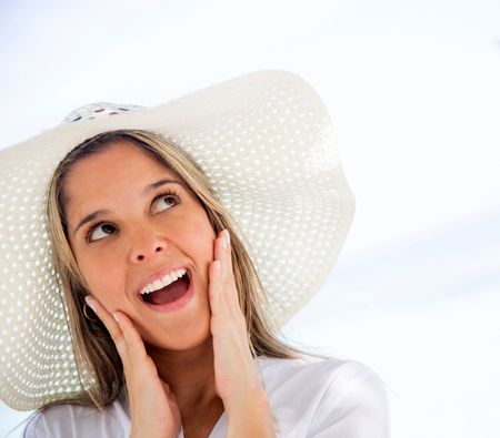 Thoughtful woman on holidays wearing a summer hat