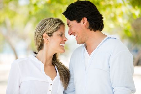 Cute couple in love walking outdoors and looking happy