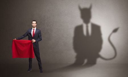 businessman-standing-red-cloth-hand-devil-1258480561 Businessman standing with red cloth in his hand and devil shadow on the background