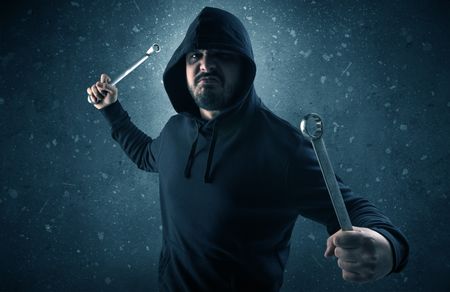 masked-armed-villain-empty-dark-room-1258482733 Masked armed villain in empty dark room with gun ax chainsaw mallet wrench