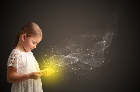 Little cute girl playing on sparkling tablet