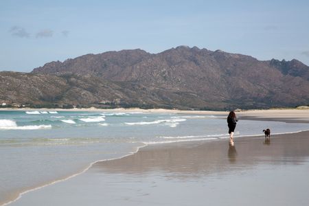 Woman and Dog at Beach in Galicia Spain