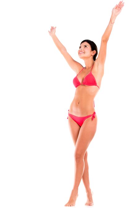 Happy woman in bikini with arms up - isolated over white