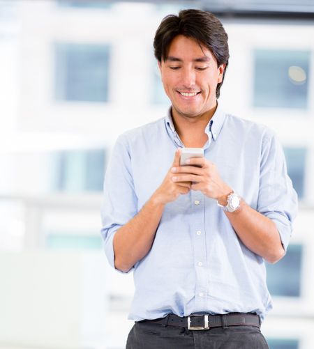 Happy businessman with thumbs up at the office