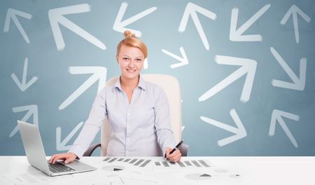 Business person sitting at desk with different direction concept