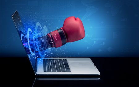 Hand with box gloves coming out of a laptop with sparkling effects