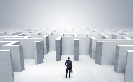 Businessman choosing between entrances in a middle of a maze