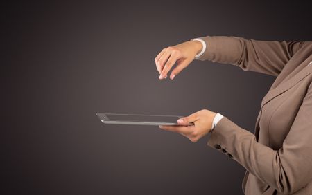 Female hand in suit holding tablet with no wallpaper