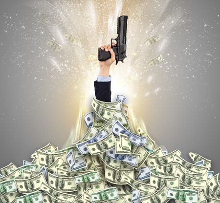 Hand bursting from a huge money pile